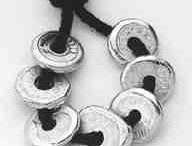 This picture (left) shows seven "doughnut" bars of 1.2 ounces each. The doughnut shape is a traditional Chinese shape for coinage. The pig bar, issued in 1991 by LD Metals of South Korea, is 38 mm wide and weighs 18.75 grams. The tiny hog is a popular gift item.