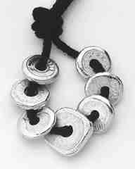 This picture (left) shows seven "doughnut" bars of 1.2 ounces each. The doughnut shape is a traditional Chinese shape for coinage. The pig bar, issued in 1991 by LD Metals of South Korea, is 38 mm wide and weighs 18.75 grams. The tiny hog is a popular gift item.