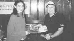 Caitlin Kearns receives several gifts from Dufferin Aggregates resource supervisor Sergio Carbone after touring the company's rock quarry in Milton, Ont.