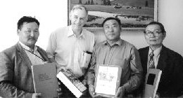 Photo by Gerald HarperGeoscience textbooks arrive in Mongolia. Batmunkh Gandush (left), founder of the International Exchange Centre for Geologists and Miners; Gerald Harper; D. Chuluun, director of the MTU School of Geology; Prof. J. Lhamsuren, emeritus director of the school.