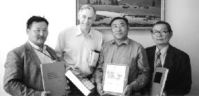 Photo by Gerald HarperGeoscience textbooks arrive in Mongolia. Batmunkh Gandush (left), founder of the International Exchange Centre for Geologists and Miners; Gerald Harper; D. Chuluun, director of the MTU School of Geology; Prof. J. Lhamsuren, emeritus director of the school.