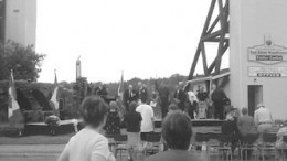 Onlookers watch as Benot Serr, member of Parliament for Timiskaming-Conchrane, declares the Cobalt mining district a national historic site. The headframe on the left was taken from the nearby Pan Silver mine.