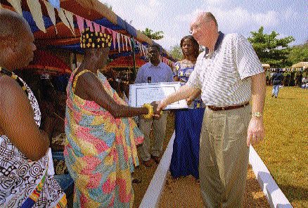 Newmont Mining Chairman and CEO Wayne Murdy greets the locals in Ghana, where the company is developing its multi-million-ounce Ahafo and Akyem gold projects.