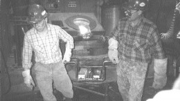 Workers carry off freshly poured gold bars at Kinross Gold's Kubaka mine in Russia's Far East.