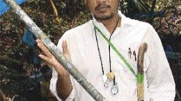A local geologist holds massive quartz-copper mineralization from the Baroi project in Indonesia.