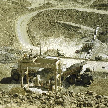 Trucks unload copper ore into a crusher at the Cerro Verde mine in Peru.