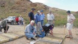 Exeter Resource chairman Yale Simpson (foreground) and a group of analysts and fund managers examine core from the La Cebeza gold project in Argentina.