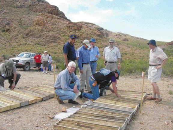 Exeter Resource chairman Yale Simpson (foreground) and a group of analysts and fund managers examine core from the La Cebeza gold project in Argentina.