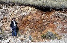 SOUTHWESTERN RESOURCESJohn Paterson, president and CEO of Southwestern Resources, stands by an exposure of zinc oxide mineralization at the Accha deposit in southern Peru.