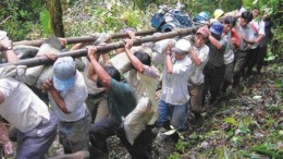 AURELIAN RESOURCESLabourers carry part of a drill supported on casings through the Ecuadorian forest at Aurelian Resources' Condor gold-silver project.
