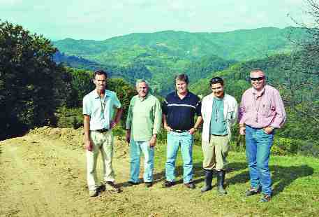 PHOTO BY JOHN CUMMINGCarpathian Gold personnel standing near the Colnic gold-copper porphyry in Romania, with the Rovina copper-gold porphyry in the distance, from left: chief operating officer Randall Ruff; president and CEO Dino Titaro; investor relations manager Michael O'Brien; geologist Albert Fuer; and consulting geologist Sorin Halga.
