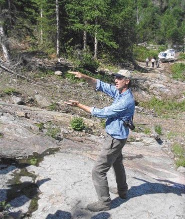 David Good, Marathon PGM's vice president, exploration, illustrates a point at the Malachite Zone of the Coldwell intrusive complex.
