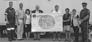 Presenting the Goldcorp cheque to the CNIB Eye Van staff in Red Lake, from left: Ted Turgeon, NW EMS Red Lake ambulance coordinator; Dr. El-Defrawy, Eye Van ophthalmologist; Natasha Marlow, Eye Van staff; John Whitton, community relations officer at Red Lake Gold Mines; Mike Lalonde, Red Lake mine general manager; Darla Pfahler, Eye Van staff; Toots Everley, Red Lake Lions Club; and Rob Monk, Ontario Provincial Police sergeant.