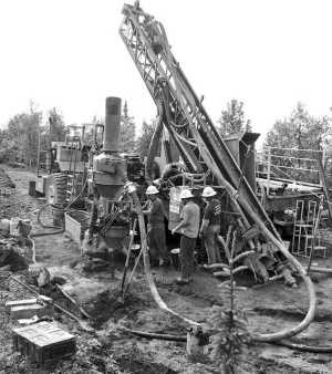 Workers operate a drill rig at International Tower Hill Mines' Livengood gold project north of Fairbanks, Alaska.