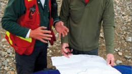 Rio Minerals' Andrew Molnar and Smash Minerals CEO Adrian Fleming study a map at Smash's Whiskey gold project in the Yukon's White Gold district. Photo by Smash Minerals