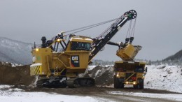 A shovel dumps a load into a haul truck as Thompson Creek strips overburden in preparation to start mining the North pit at Mt Milligan. Credit: Thompson Creek Metals