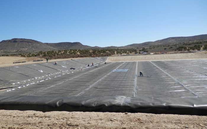 Workers lining a pond that will hold pregnant solution at Midway Gold's Pan gold project, 35 km southeast of Eureka, Nevada. Credit: Midway Gold