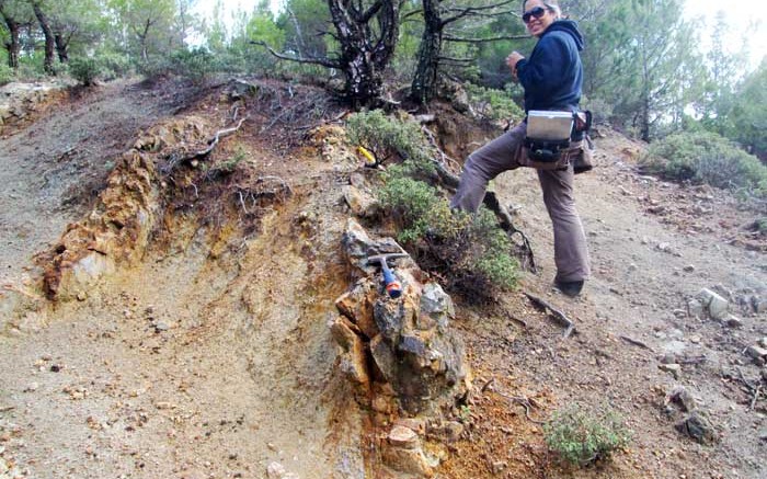 Pilot Gold geologist April Barrios examines a zone of phyllic alteration and quartz veining cross-cutting potassic-altered granodiorite in the central part of the Valley porphyry soil anomaly, at the TV Tower project in Turkey. Credit: Pilot Gold