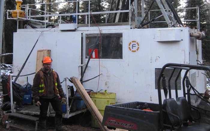Transition Metals geologist Steve Flank standing in front of the discovery hole at the Sunday Lake PGM project, 25 km north of Thunder Bay, Ontario, in November 2013. Credit: Transition Metals
