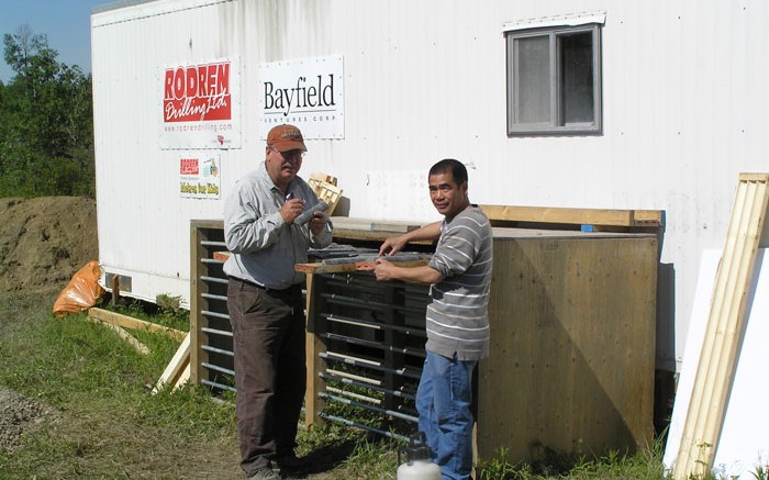 Bayfield Ventures' vice-president of exploration Bob Marvin (left) and project geologist Shane Hu examine core at the Burns Block gold project in Ontario. Credit: Bayfield Ventures