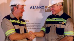 Peter Breese (left), Asanko Gold's president and CEO, and Colin Steyn, chairman, shake hands over a gold bar from the Asanko gold mine in Ghana. Credit: Asanko Gold