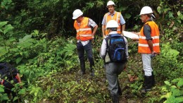 Inspecting drill collars at the Santa Barbara gold-copper prospect, part of Ecuador Gold and Copper’s Condor property in Ecuador, from left (in orange vests): Marshall Koval, Odin Mining’s president and CEO, and Odin directors John Youle and Diego Benalcazar.  Credit: Odin Mining.