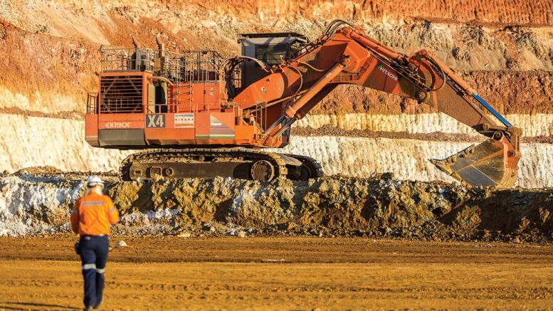 A worker walks towards an excavator and Glencore’s Murrin Murrin nickel-cobalt mine in Western Australia. Credit: Glencore.