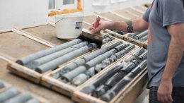 A worker wets drill core from the Colomac deposit at Nighthawk Gold’s Indin Lake gold project. Credit: Nighthawk Gold.